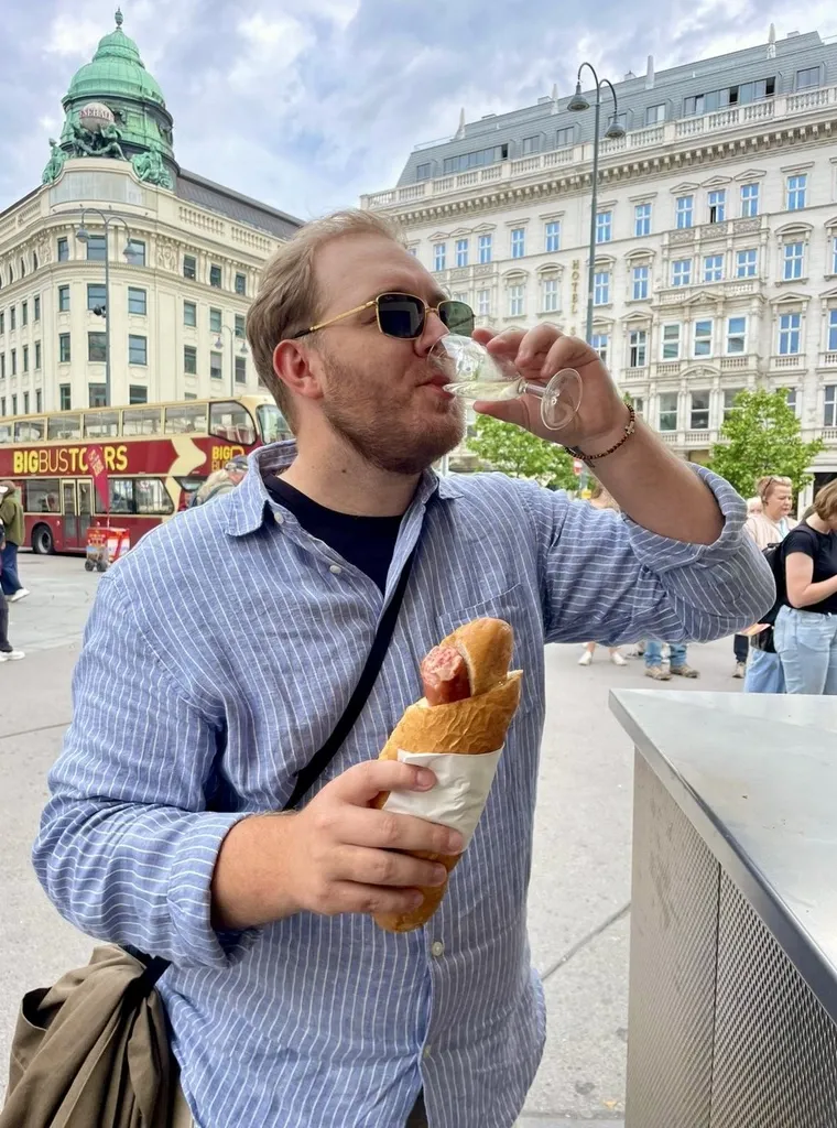 Parker McCrary eating a kasekrainer in Vienna, Austria